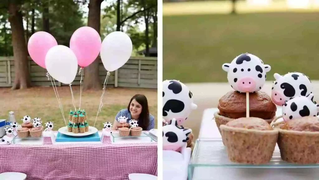 A farm-themed birthday party setup featuring pink and white balloons, cow-shaped cupcake toppers, and a smiling woman behind a gingham tablecloth. The table displays cupcakes and treats decorated with cow designs, adding a playful farmyard vibe.